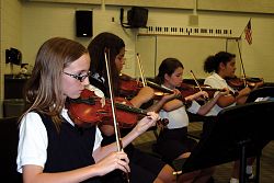 Anonymous donor plays the strings for Catholic schools 